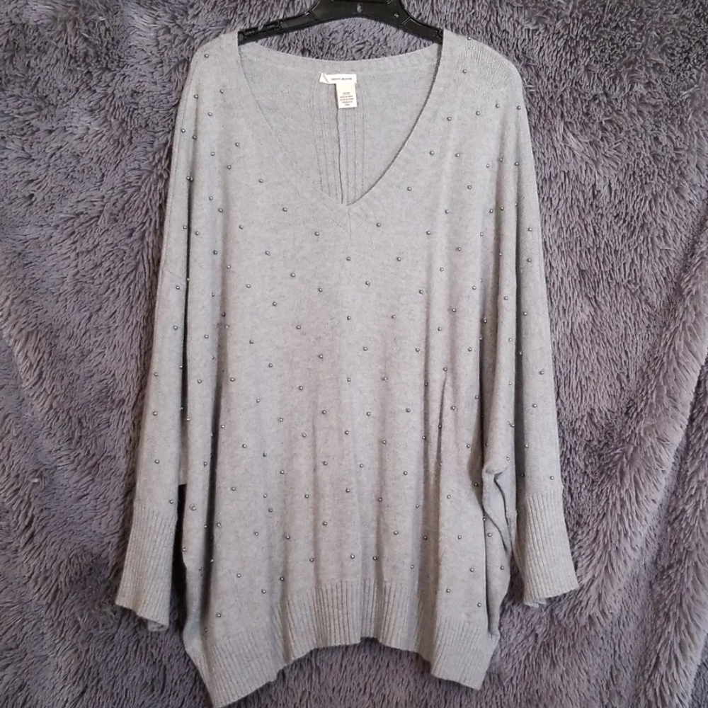 Sweater with gray pearls on it.
